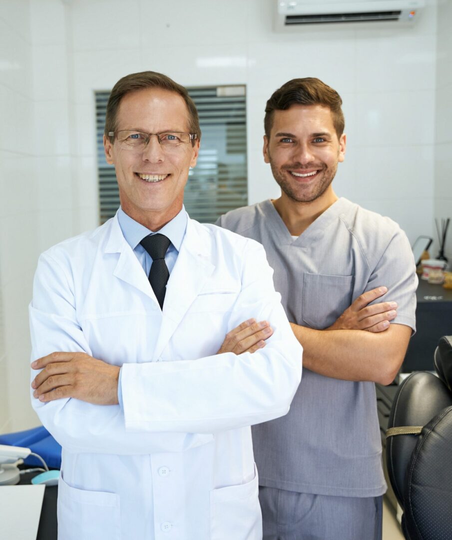 Two doctors standing next to each other in a room.