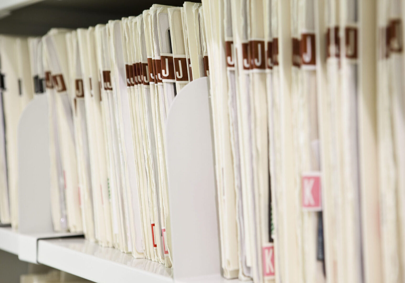 A row of papers on top of a shelf.